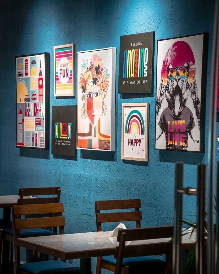 Mastering the First Impression: Your intriguing post title goes here Vibrant wall art display enhances a cozy cafe interior, perfect for design inspiration.