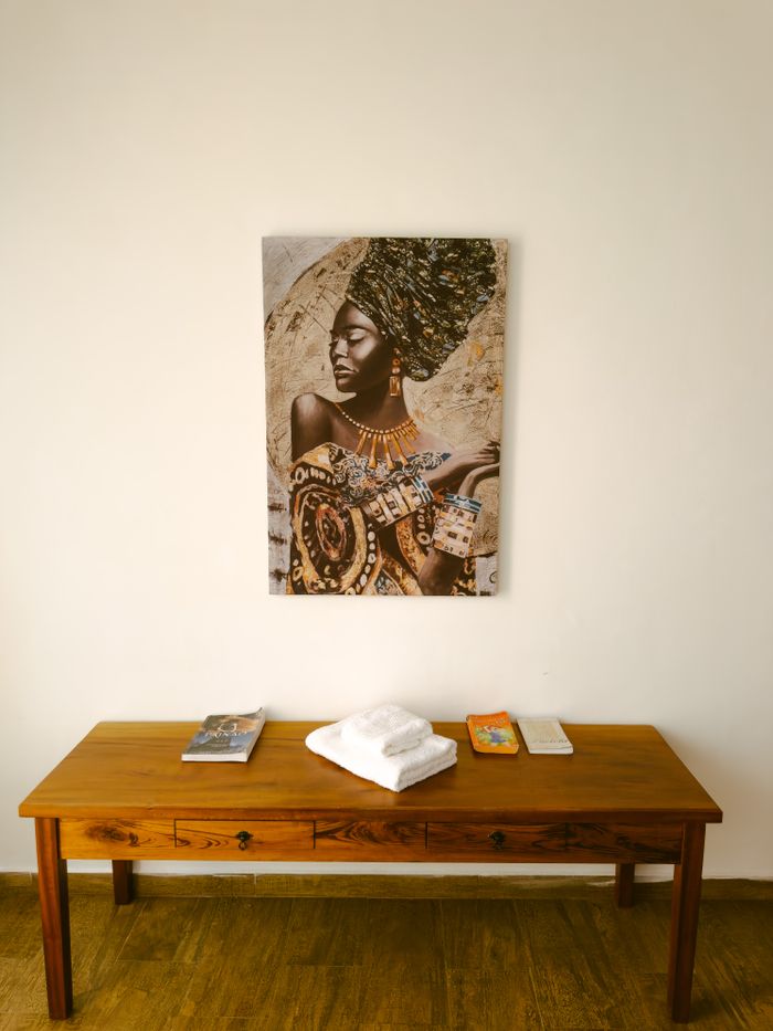 Crafting Captivating Headlines: Your awesome post title goes here Stylish interior with a wooden table and African-inspired wall art.